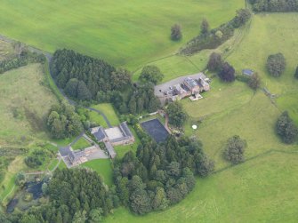 Oblique aerial view of Mossknowe House and policies, taken from the SW.