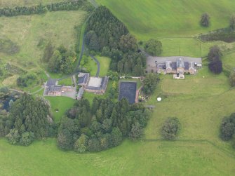 Oblique aerial view of Mossknowe House and policies, taken from the SSW.