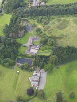 Oblique aerial view of Mossknowe House and policies, taken from the ESE.