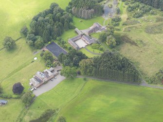Oblique aerial view of Mossknowe House and policies, taken from the ENE.