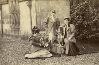View of three ladies with dogs outside St Fort House.

