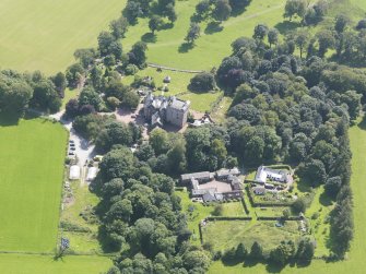 Oblique aerial view of Comlongon Castle and policies, taken from the NNW.