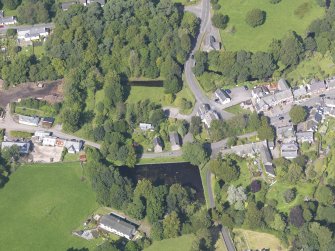 Oblique aerial view of New Abbey, centred on the parish hall, taken from the NW.