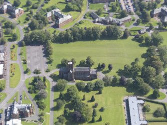 Oblique aerial view of Crichton Royal Hospital, centred on Crichton Memorial Church, taken from the NW.