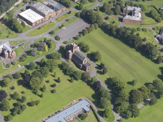 Oblique aerial view of Crichton Royal Hospital, centred on Crichton Memorial Church, taken from the WNW.
