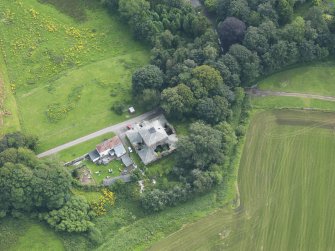 Oblique aerial view of Carnsalloch House stables and cottage, taken from the NNE.
