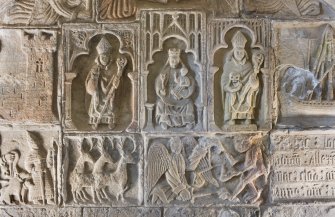 Detail of the 16th century tomb of Alasdair Macleod, 8th Chief of Macleod. Central panels showing Blessed Virgin with Child flanked by a bishop (left) and St Clement (right). Below this is part of the hunting scene, and Michael and Satin at the weighing of souls.