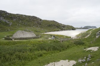 General view of reconstructed Iron Age house at Bosta, taken from E