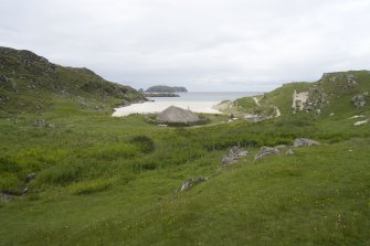 Location view of  the reconstructed Iron Age house in relation to  the coastline, taken from SSE