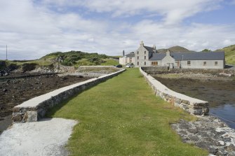 View of Rodel Hotel, Harris, looking along south wall of harbour, from south-east.