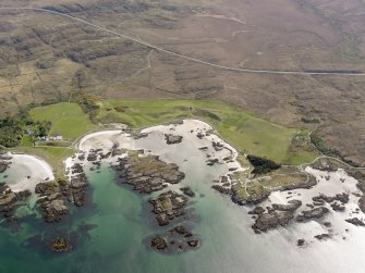 Oblique aerial view of Traigh, centred on Traigh Golf Course, taken from the NW.