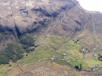 Oblique aerial view of the remains of the township, field system and cultivation remains at Kilbride, also showing the location of High Pasture Cave, Strath Suardal, Skye, taken from the NNE.