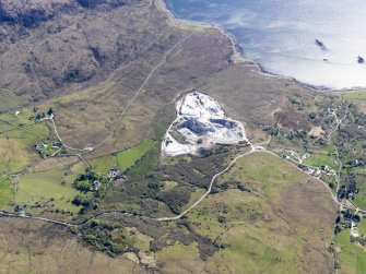 Oblique aerial view of the Cnoc Dubh marble quarry at Torrin, also showing the nearby remains of field systems, head dykes and lazy beds at Torrin and Kilbride, Skye, taken from the NNE.