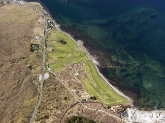 Oblique aerial view of the remains of fish traps near Sconser golf course, and the remains of Achadh Mor township, field system and lazy beds, Skye, taken from the SE.