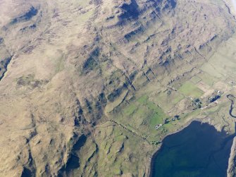 Oblique aerial view of the remains of the township, field system and lazy beds at Cnoc Loisgte and the remains of two fish traps at the head of Loch Eynort, Isle of Skye, taken from the S.