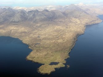 General oblique aerial view of the remains of the harbour at Rubh' an Dunain, looking towards the Cuillins, Isle of Skye, taken from the WSW.