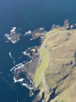 Geeral oblique view of the W end of Canna centred on the fort of Dun Channa, taken fromt he S.