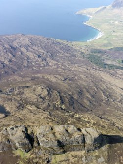 General oblique aerial view looking over the fort of An Sgurr towards the N end of Eigg, including Bay of Laig and Cleadale, taken from the SSW.