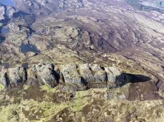 General oblique aerial view of the fort on An Sgurr, Eigg, with Bay of Laig Bay beyond, taken from the