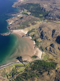 General oblique aerial view looking along the shore at the south end of Gruinard Bay with Gruinard House in the distance, taken from the SW.