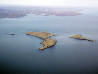 General oblique aerial view of the Shiant Islands with Lewis in the distance, taken from the SSE.
