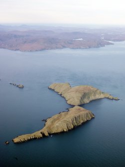 General oblique aerial view of the Shiant Islands with Lewis in the distance, taken from the SE.