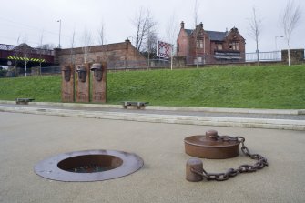 View of public art in the former basin of the Monkland Canal, with the Central Station building behind, taken from the south
