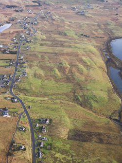Oblique aerial view of the remains of  Leurbost township, with associated head dyke, field system and lazy beds, Isle of Lewis, taken from the W.