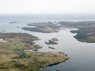 General oblique aerial view of the remains of Ceos Blackhouse,  Keose township and associated head dyke, field system and cultivation remains, looking across Loch Eirasort on the E coast of Lewis, taken from the WNW.