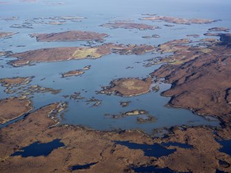 General oblique aerial view of Orasaigh and Loch Aulasary, looking across to Tobha Beag and Taghaigh, showing the location of the remains of the possible farmstead at Loch Aulasary, N Uist, taken from the WSW.