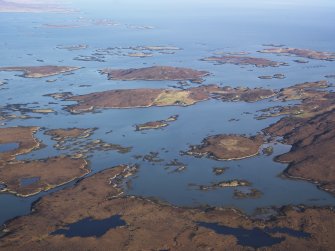 General oblique aerial view of Orasaigh and Loch Aulasary, looking across to Tobha Beag and Taghaigh, showing the location of the remains of the possible farmstead at Loch Aulasary, N Uist, taken from the WSW.