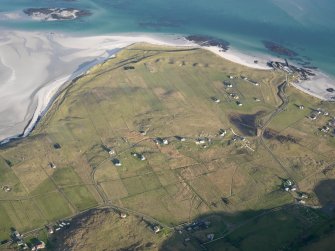 General oblique aerial view of the remains of the field system at Eoligarry, including the remains of a chapel and burial ground, looking towards the pier, Barra, taken from the SW.