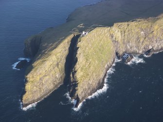 Oblique aerial view of  the remains of  Dun Briste and Sron an Duin, near Barra Head lighthouse overlooking the sea cliffs of Berneray, taken from the WSW.