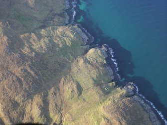 Oblique aerial view of the remains of the township, field system, head dyke and lazy beds at The Aird and Maclean's Point, Berneray, taken from the SE.