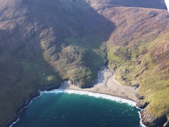 Oblique aerial view of the remains of the township and field system at Mingulay Bay, Mingulay, taken from the E.