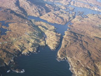 General oblique aerial view of the remains of the township of Balnabodach, and nearby head dyke, field system and lazy beds, Barra, taken from the SE.