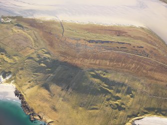 Oblique aerial view of the remains of the field system, lazy beds and enclosures near Northton, Harris, taken from the SW.
