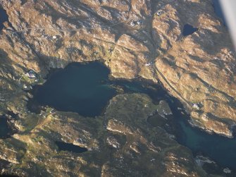 Oblique aerial view of the remains of the townships of Manish and Ardslave, with nearby remains of a head dyke, enclosures and lazy beds, Harris, taken from the S.