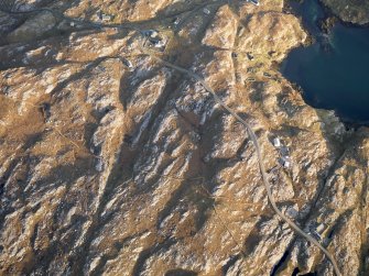 Oblique aerial view of the remains of the eastern end of the township of Manish, including the possible remains of a horizontal mill, with the nearby remains of a head dyke and lazy beds, Harris, taken from the W.