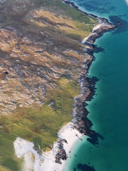 General oblique aerial view of the remains of a Dun at Clett An Duin, the remains of the township of Raah and the nearby dykes and lazy beds, Taransay, Harris, taken from the SW.