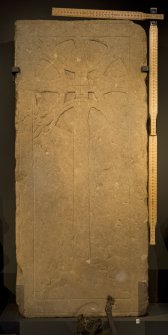 View of carved cross slab in display case