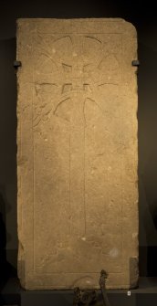 View of carved cross slab in display case (including scale)