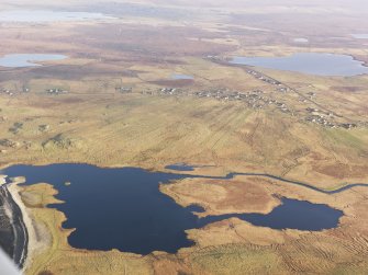 General oblique aerial view looking across Loch Arnol towards Arnol township, taken from the W.
