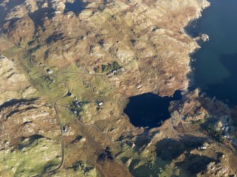 Oblique aerial view of the remains of the township, head dyke and lazy beds at Calbost, Loch Dubh, Lewis, taken from the SW.
