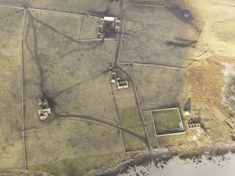 Oblique aerial view of the remains of Vallay House and Old Vallay House, Vallay, North Uist, taken from the SSE.