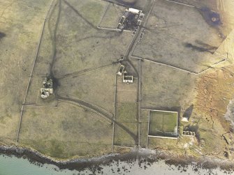 Oblique aerial view of the remains of Vallay House and Old Vallay House, Vallay, North Uist, taken from the SE.