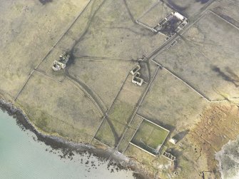 Oblique aerial view of the remains of Vallay House and Old Vallay House, Vallay, North Uist, taken from the ESE.