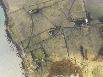 Oblique aerial view of the remains of Vallay House and Old Vallay House, Vallay, North Uist, taken from the E.
