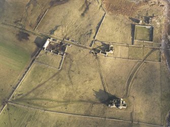 Oblique aerial view of the remains of Vallay House and Old Vallay House, Vallay, North Uist, taken from the SW.