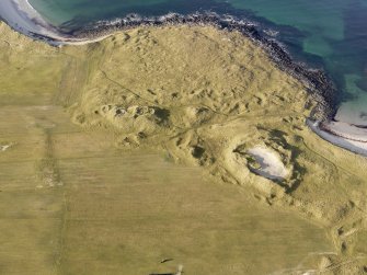 Oblique aerial view of the remains of the settlement at the Udal, North Uist, taken from the ESE.